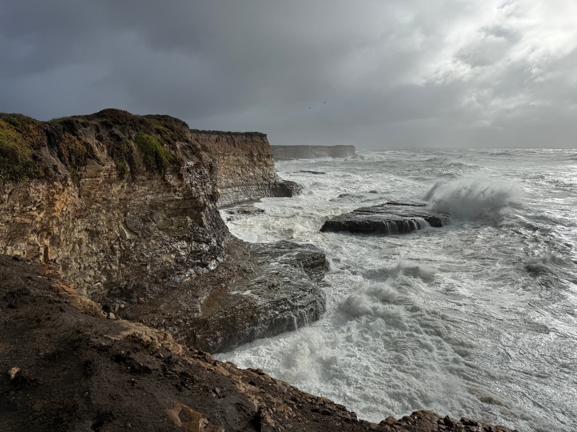 Dramatic coastal cliffs and churning surf along the California coast