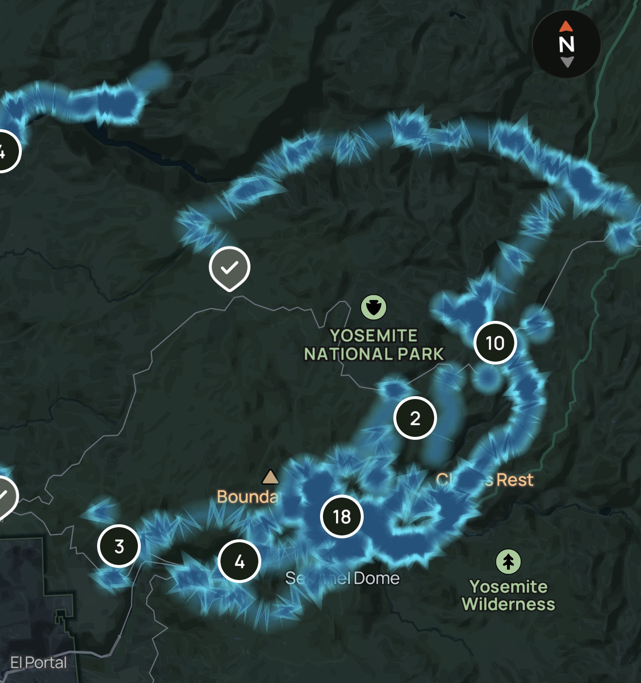 A dark Yosemite map screenshot with bright blue routes, numbered clusters, route markers, and a north compass
