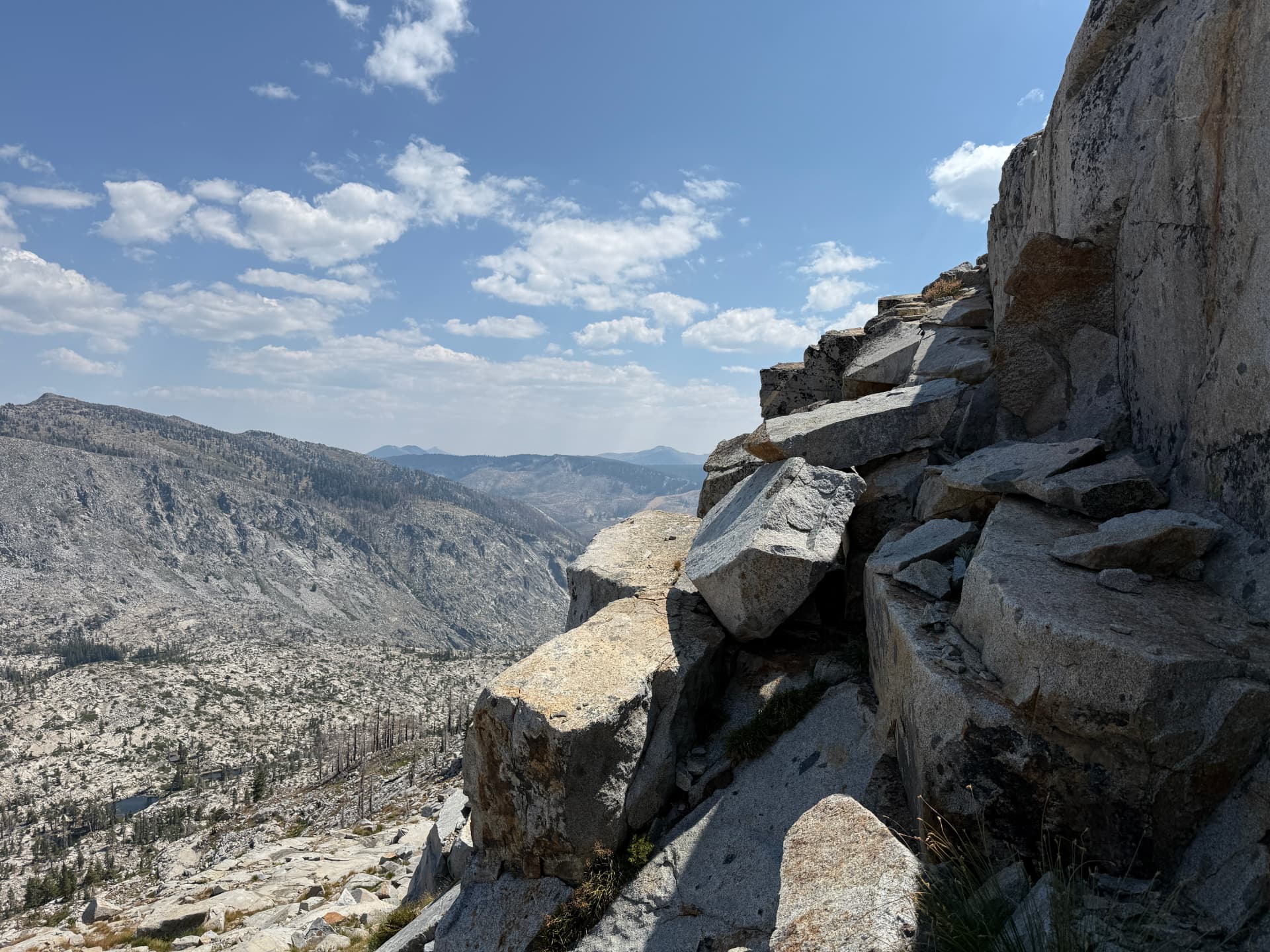 Granite slabs and a high alpine valley below Pyramid Peak