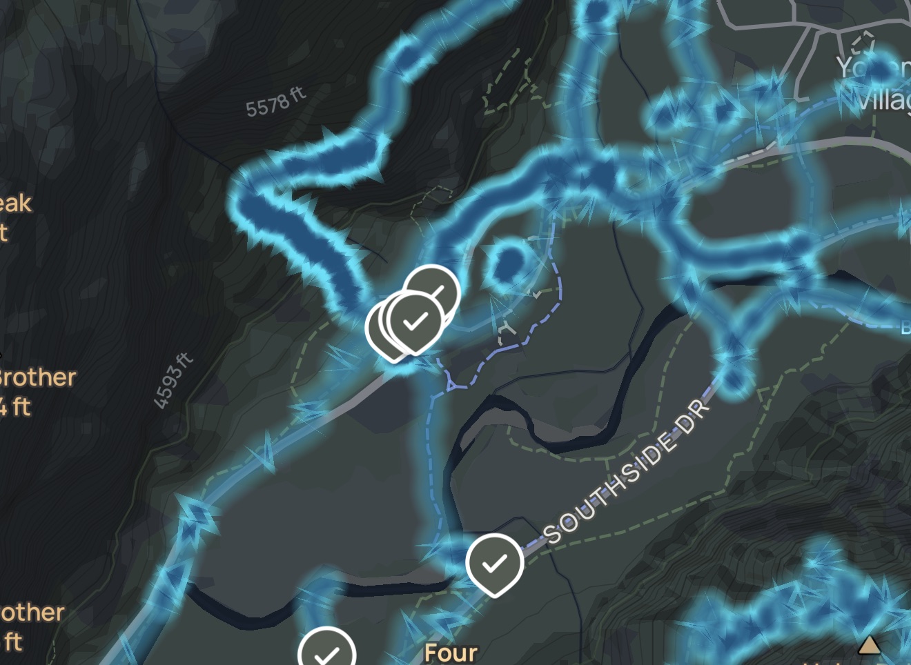 A dark map screenshot with bright blue overlapping routes, white route markers, and map labels